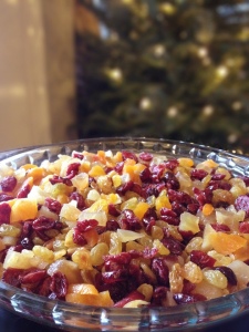 dried fruit in a bowl with christmas tree and lights