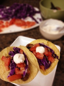 vegetarian tacos with tomatoes, mushrooms, and cabbage